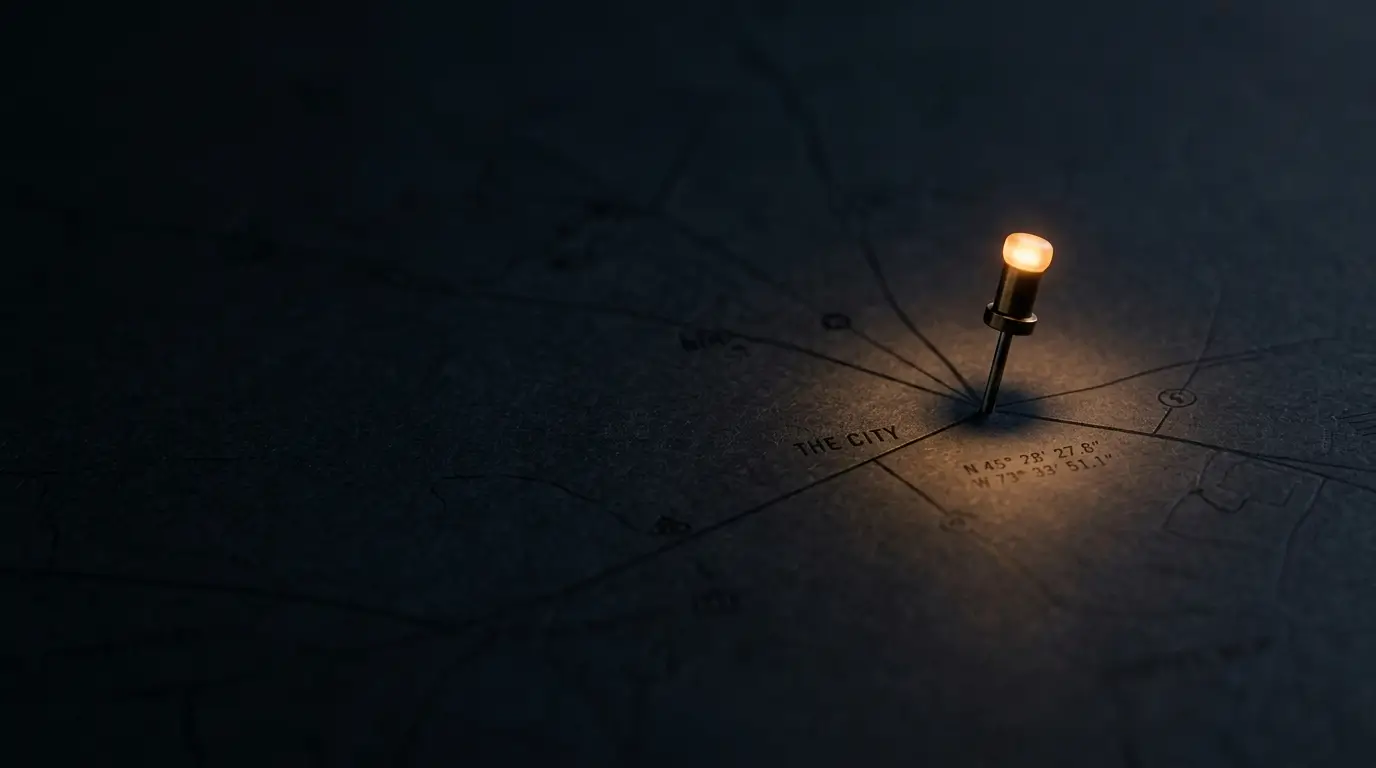 A glowing location pin on a dark map, lit warmly from above.